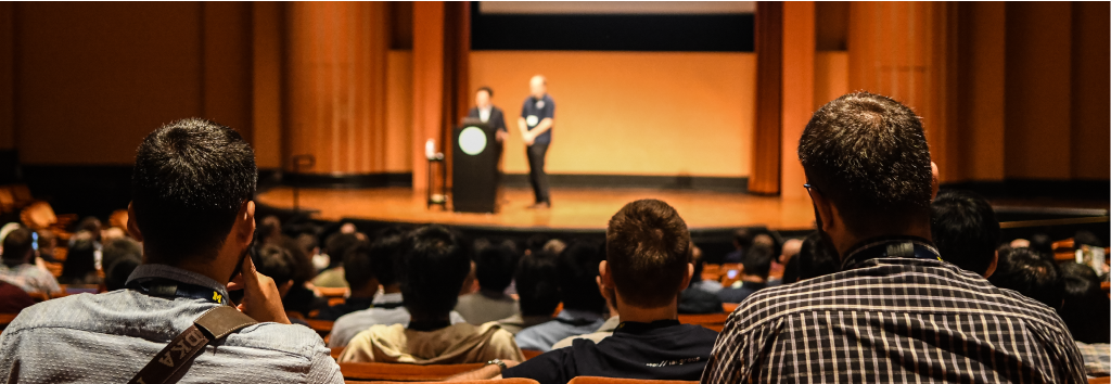 Conference attendees at Rackham Auditorium