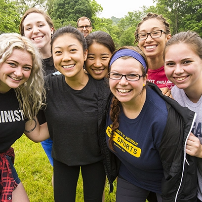 A group of 8 students with smiling faces