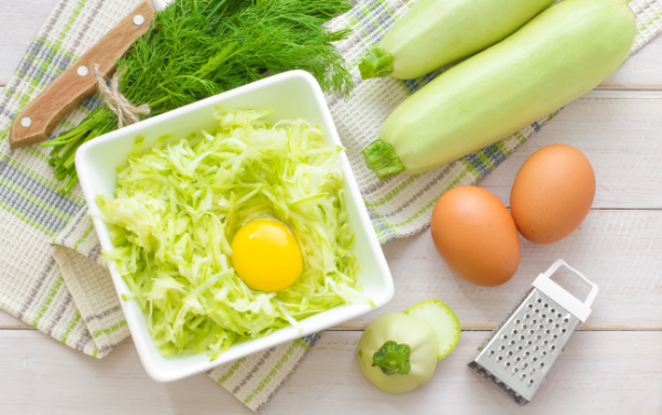 Fresh vegetables, eggs, and cooking prep items on a counter