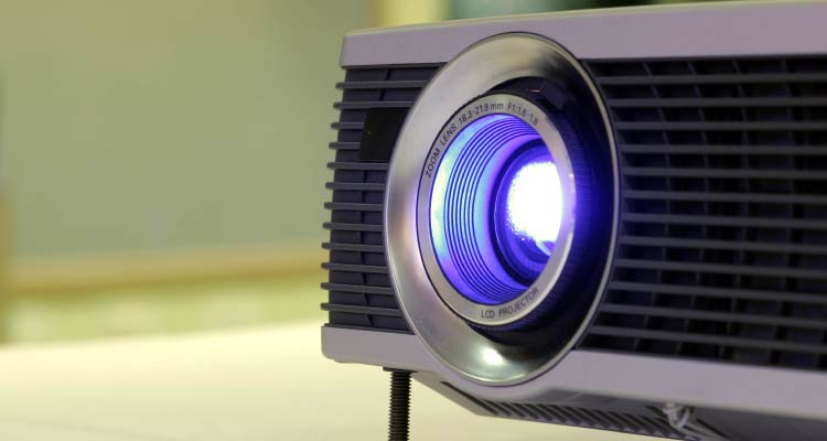 A close up of a projector on a table.