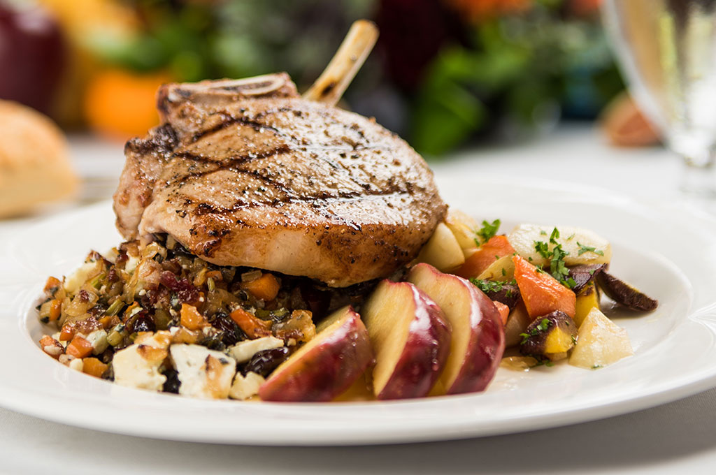 Stuffed pork chops with butternut squash risotto and roasted root vegetables